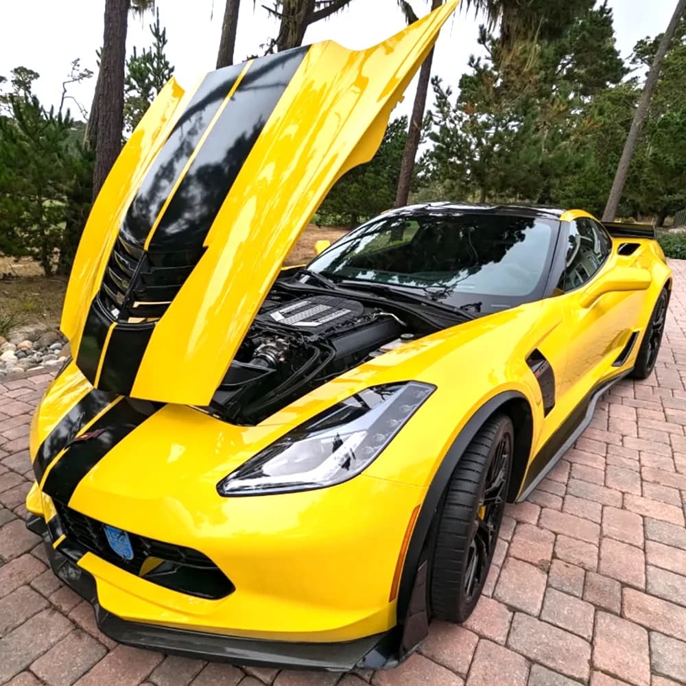 Yellow Chevrolet Corvette with the hood open after a Cortes Express detail