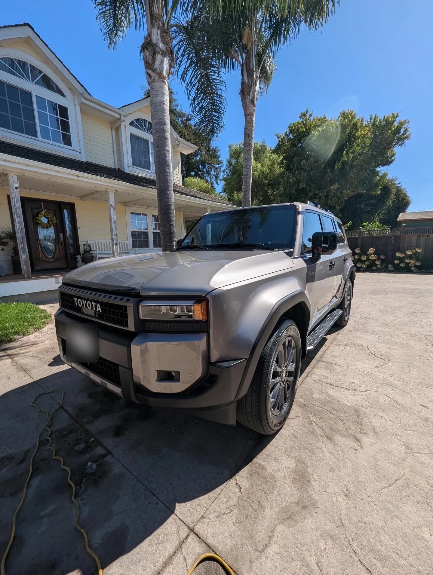 Gray Toyota Land Cruiser after a wash in the owner's driveway